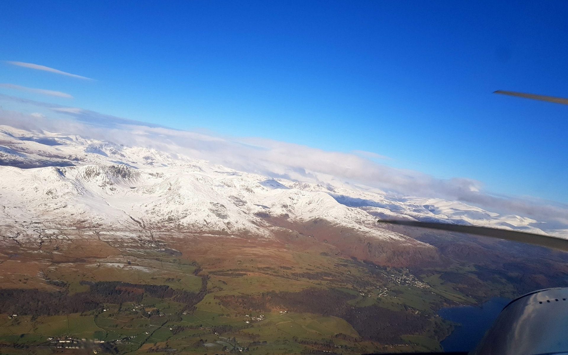 Snowy mountains and lake district on the right